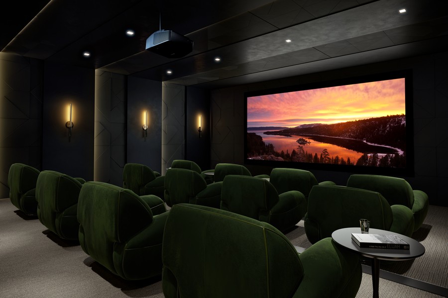 A luxurious Chicago home theater with green velvet individual lounge chairs, a large screen, and a surround sound system. 