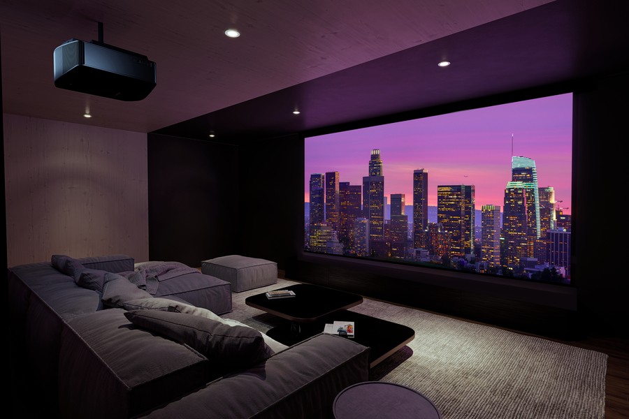 A luxurious Chicago dedicated home theater with comfortable sofa seating, a large screen, and a surround sound system. 