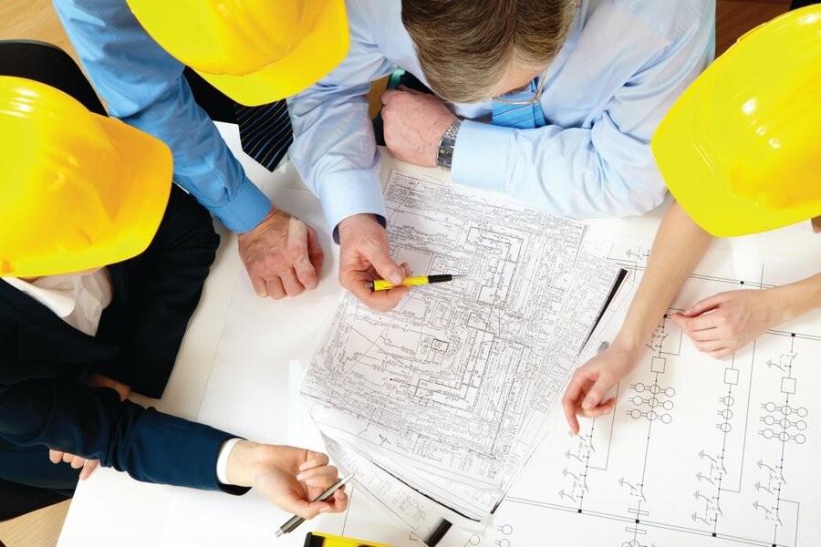 A group of people working with building plans.