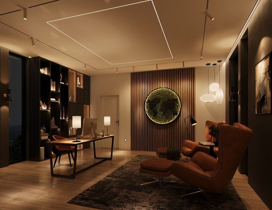 A home office space with a desk, luxurious seating, and architectural and ambient lighting.