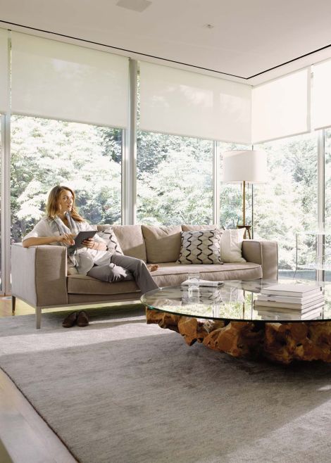 Woman sitting on couch watching tv