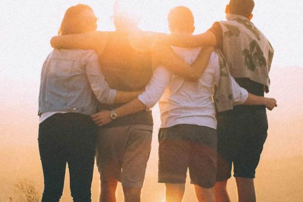 careers image, happy friends standing linking arms