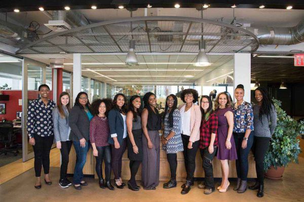 employees posing for photograph, women